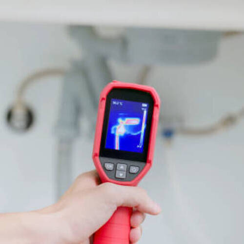 close up home inspector is using thermal imager to check water leakage situation at kitchen sink tube