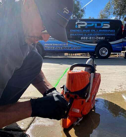 plumber performing trenchless plumbing services
